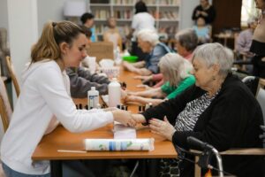 Studentky v domově seniorů, manikúra